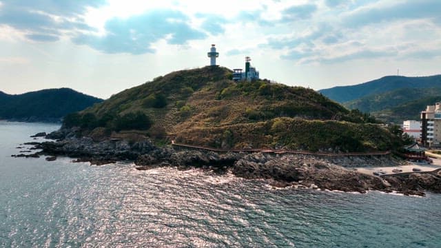 Lighthouse on a scenic coastal hill