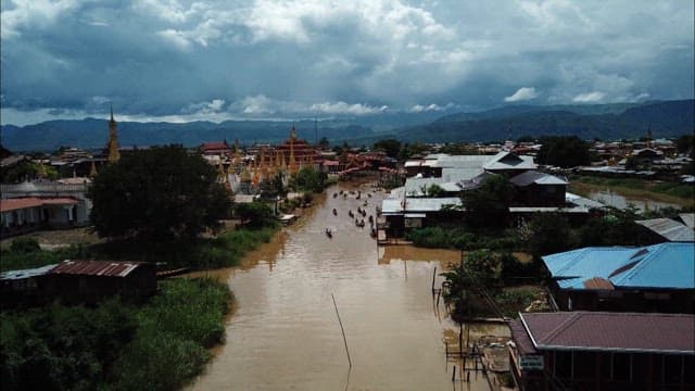 Boats transporting people on a Inle Lake village