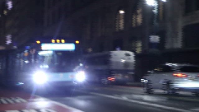 City Bus Navigating Through Night Streets