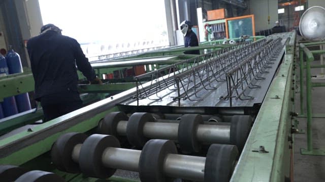 Workers operating machinery in a factory