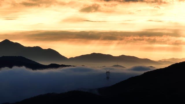 Sunrise over misty mountains