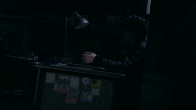 Silhouette of a Man Talking in a Dark Office