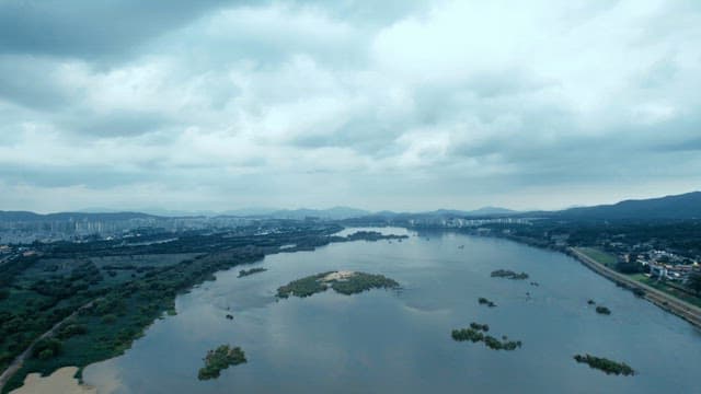 A bridge over a river with mountains