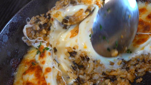 Spoonful of cheesy griddled rice