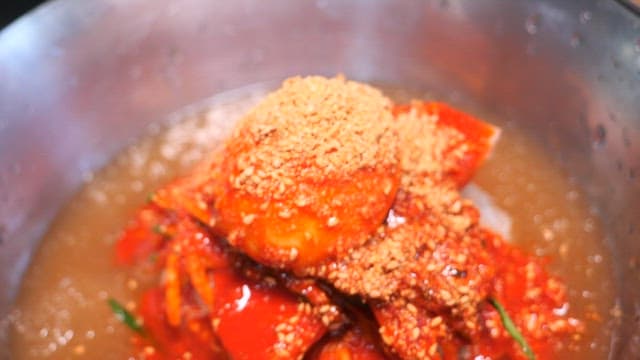 Bowl of spicy cold noodle soup with garnish