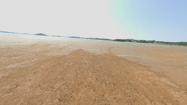 Vast sandy beach with distant hills