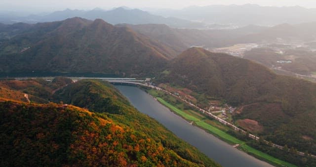 Serene River Winding Through Autumn Hills