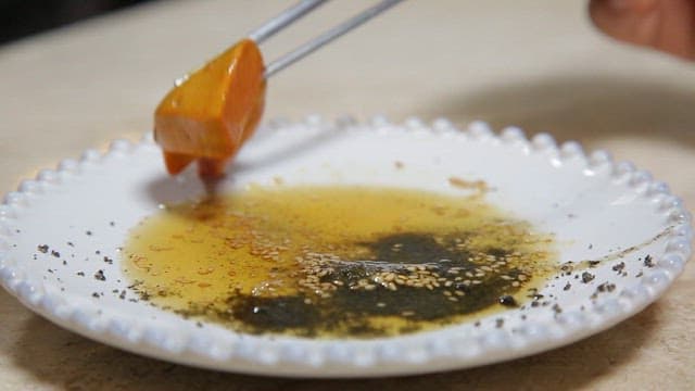 Fresh radish picked up with chopsticks