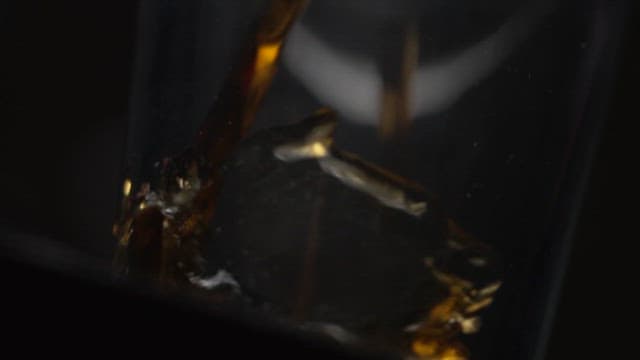Pouring Cola into a Glass Beside a Burger