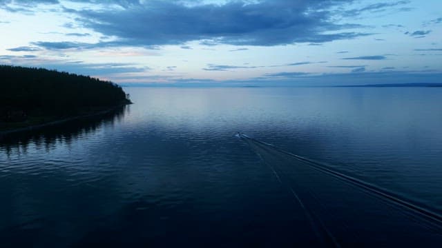 Serene lake with a boat at dusk
