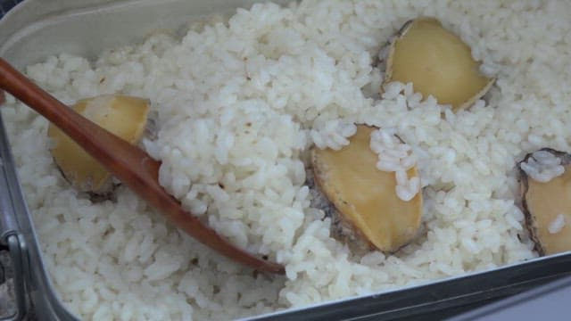 Rice with abalone cooked deliciously in a camping container