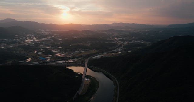 Rural Sunset Landscape with River and Road