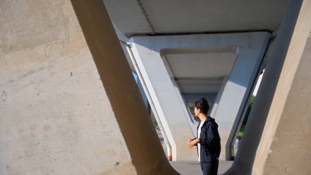 Man stretching under a bridge