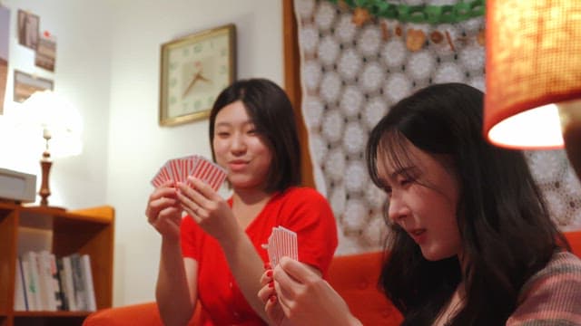 Friends playing cards in a cozy room