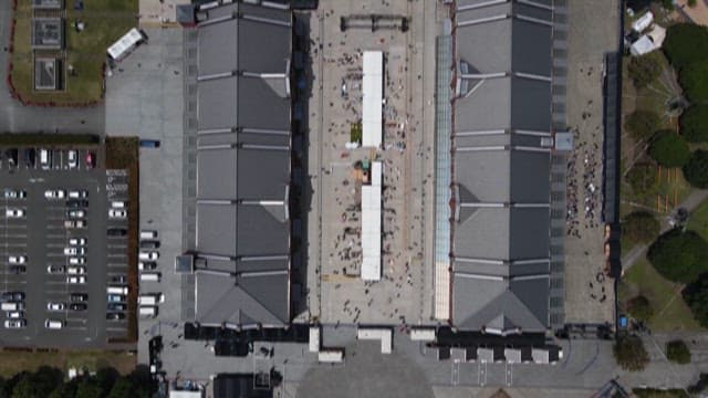 Crowded Outdoor Cultural Complex Near Warehouses