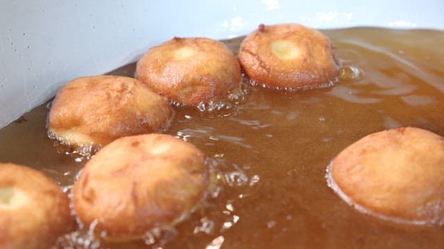 Delicious Doughnuts Frying in Hot Oil