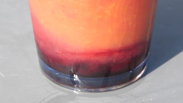 Glass cup filled with vividly colored cool grapefruit juice