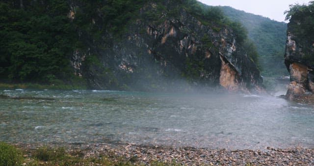 Misty River Flowing Through a Rocky Gorge