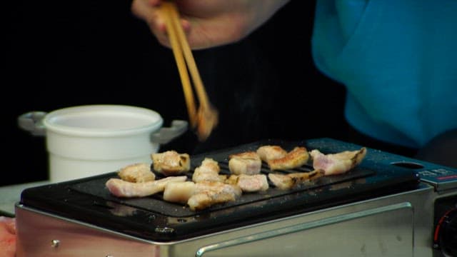 Delicious piece of grilled pork neck on an electric grill