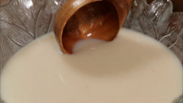 Wooden ladle scooping traditional Korean shindari