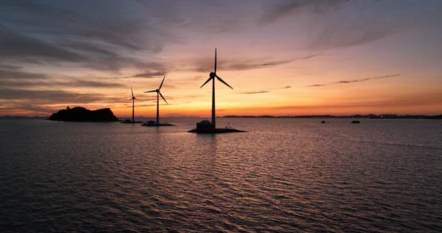 Wind Turbines at Sea During Sunset