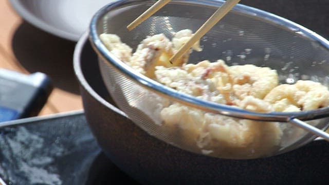 Putting the biscuit fried webfoot octopus back into the oil