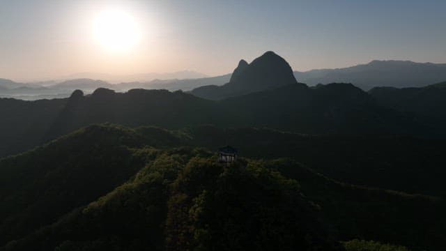 Sunlit Pavilion on a Lush and Green Mountain Peak