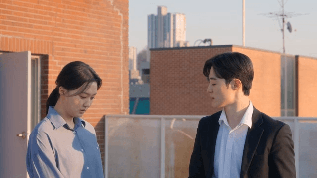 Two people conversing on a rooftop