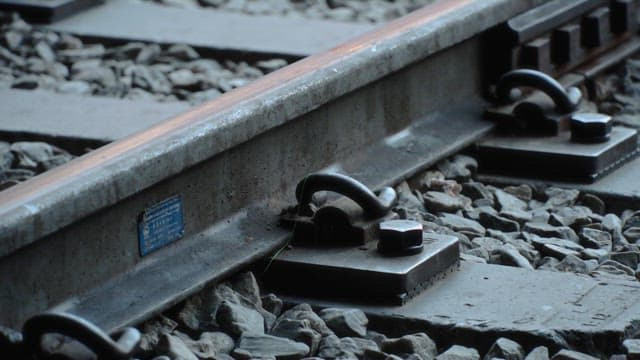 Metal rails on a gravel-covered railway track