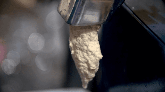 Soybean dough being extruded from a machine
