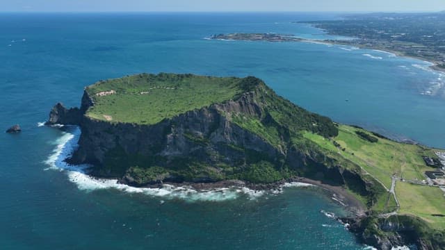 Seongsan Ilchulbong with Lush Greenery and Serene Sea on a Sunny Day