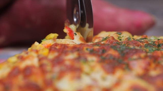 Pizza being sliced with a cutter