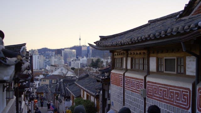 Bustling Traditional Village Against Modern Cityscape