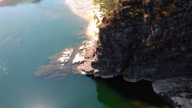 Tranquil river with rocky cliffs