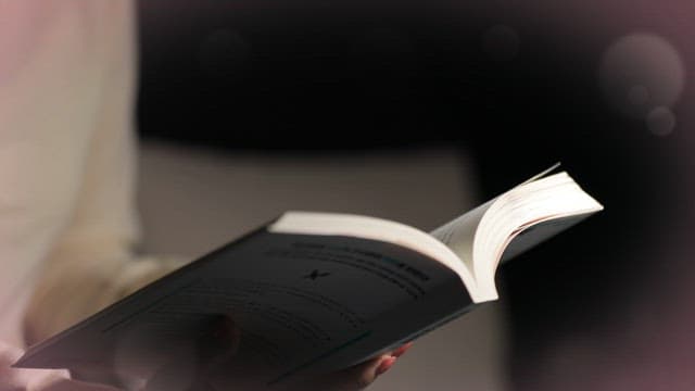 Reading a Book under the LED Stand Lamp in a Dark Room