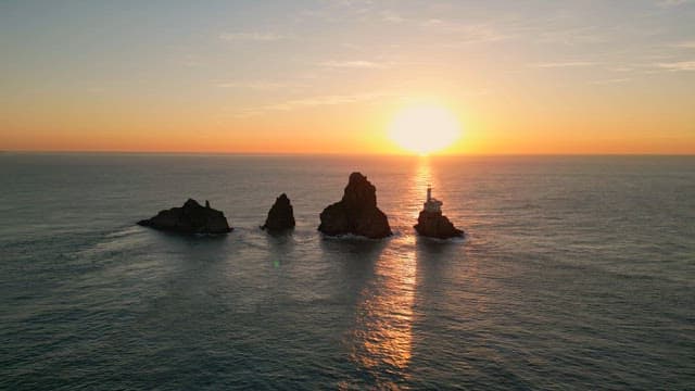 Sunset over the ocean with rocky islets