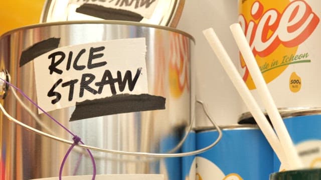 Close-up of rice straws in a metal container on a shelf.
