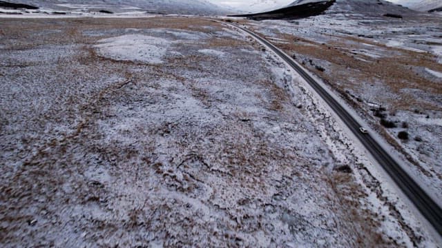 Snowy mountains and road with cars