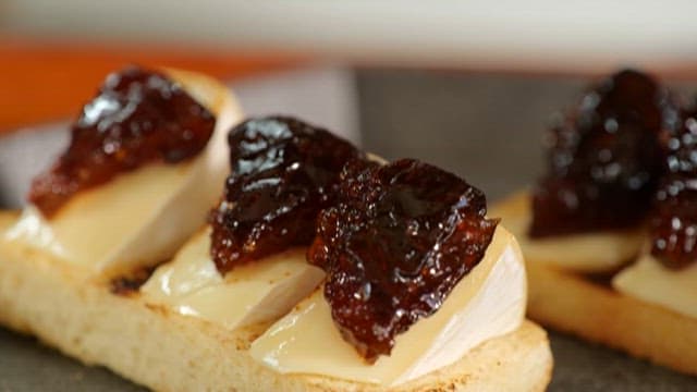 Hand Preparing Garnish on Cheese for Appetizer
