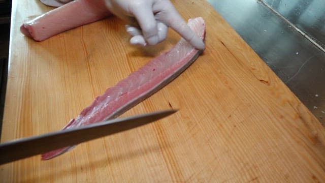 Yellow tail being sliced with precision