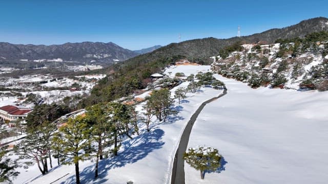 Snow-Covered Mountainous Landscape with Road