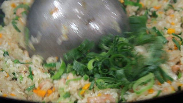 Fried rice being stirred in a pan