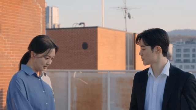 Two people conversing on a rooftop