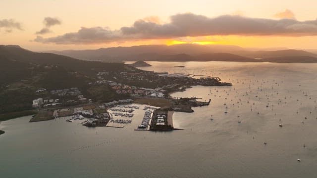 Sunset Over Coastal Marina with Boats