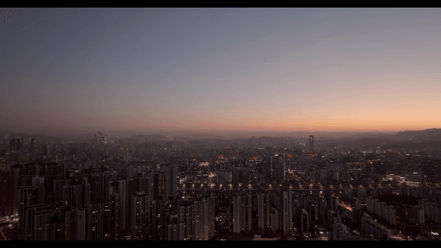 City skyline at dusk with glowing lights
