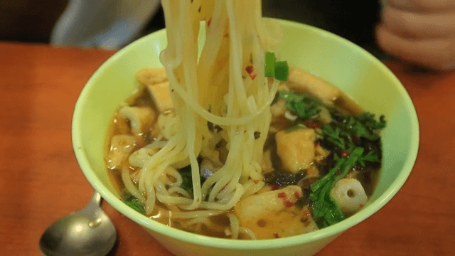 Bowl of udon with spicy sauce and fish cake