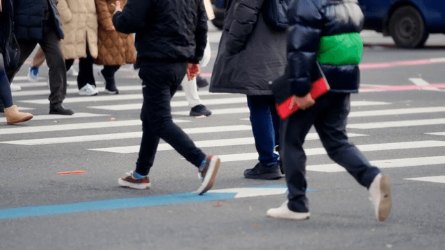 People crossing a crowded crosswalk
