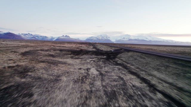Vast landscape with distant snowy mountains