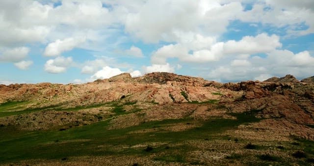 Rocky mountains under a cloudy sky