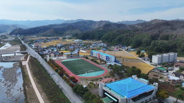 Aerial view of a school amidst a small town and farmlands